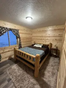 A bed room with a wooden bed and a window