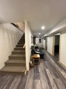A room with stairs and a couch in it