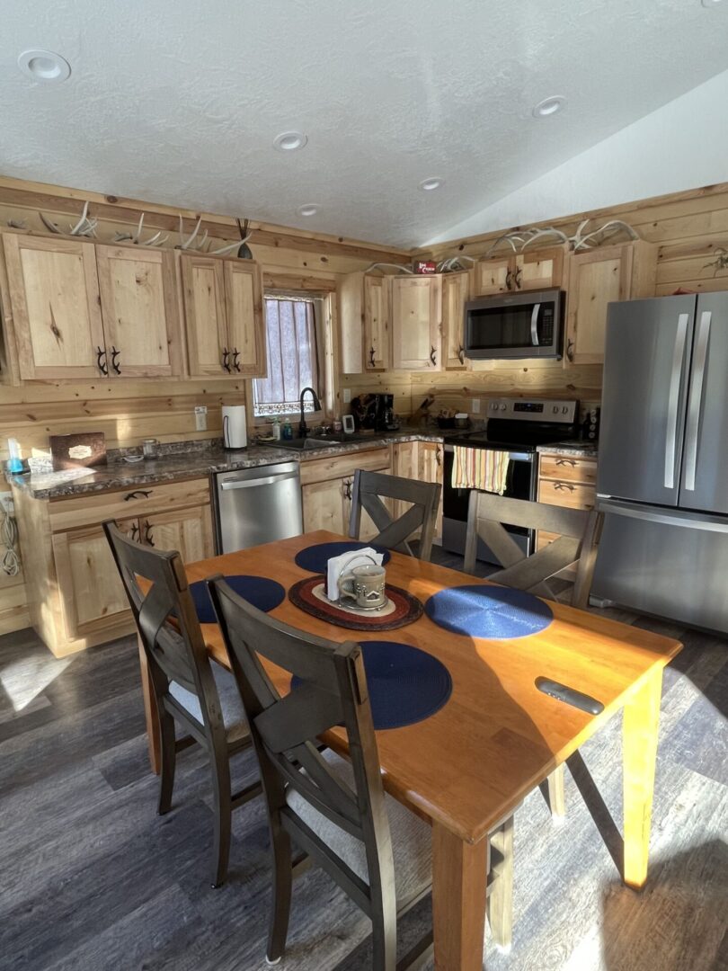 A kitchen with wooden cabinets and a table